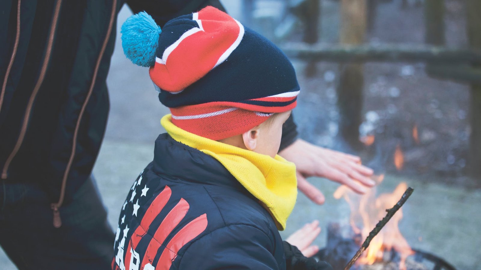 child with multi colored jacket